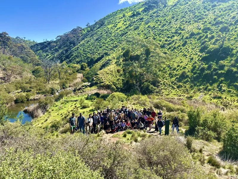 Social Hikes Australia group scrambling over rocks beside the river in Werribee Gorge — photo 8